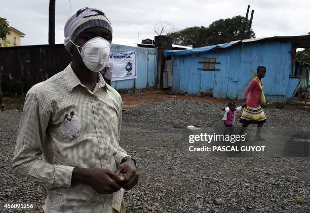 Hospital guard waits to greet patients, some suspected of suffering from the Ebola virus, in Monrovia on September 25, 2014. World leaders were asked...