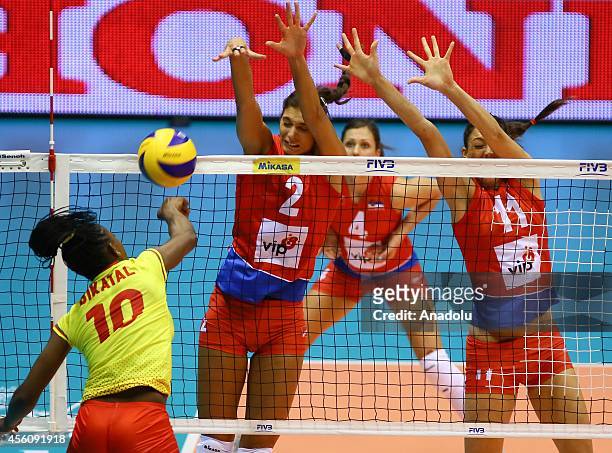 Flore Bikatal of Cameroon in action against Brakocevic and Veljkovic of Serbia during the 2014 FIVB Volleyball Women's World Championship Group B...