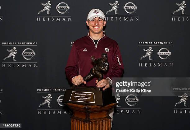 Heisman Trophy finalist Johnny Manziel, quarterback of the Texas A&M University Aggies, poses with the Heisman Trophy at the Marriott Marquis on...