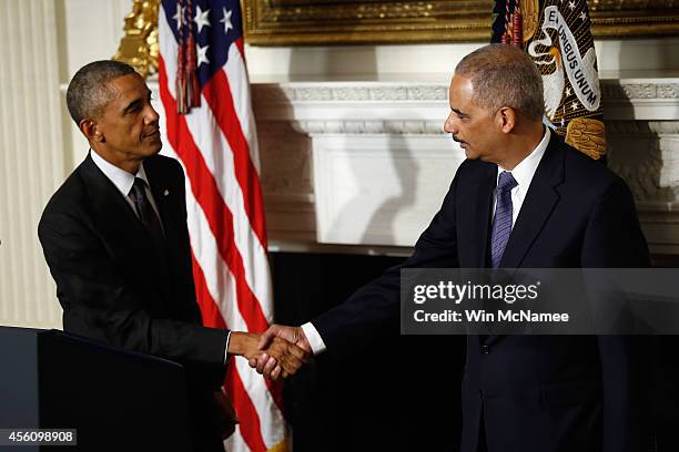 President Barack Obama shakes hands with Attorney General Eric H. Holder Jr. Who announced his resignation today, September 25, 2014 in Washington,...