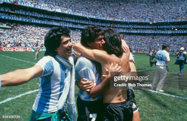 Argentina's Jorge Burruchaga is congratulated by players after scoring the World Cup Final winning goal against West Germany at the Azteca Stadium,...