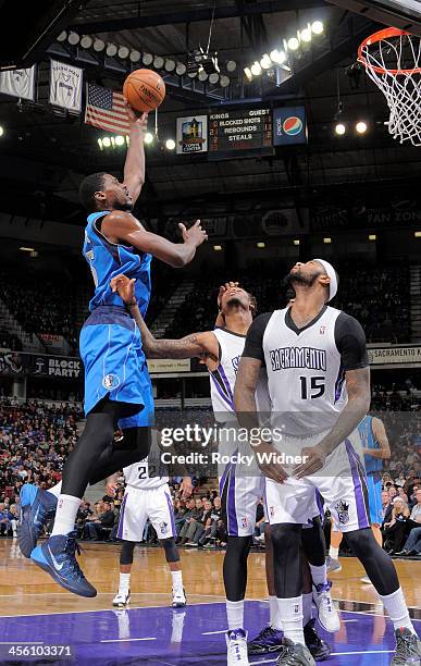 Bernard James of the Dallas Mavericks shoots against Ben McLemore of the Sacramento Kings on December 9, 2013 at Sleep Train Arena in Sacramento,...