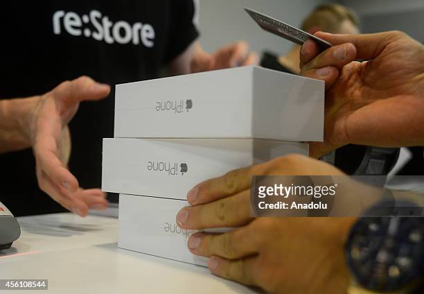 Customer pays for the new iPhone 6 in re:Store at Europeisky Shopping Mall in Moscow as iPhone 6 and iPhone 6 Plus retail sales begin in Russia on...