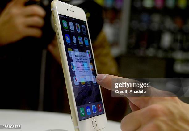 Customer touchs the iPhone 6 Plus in re:Store at Europeisky Shopping Mall in Moscow as iPhone 6 and iPhone 6 Plus retail sales begin in Russia on...