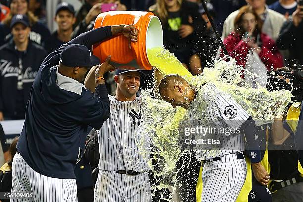 Sabathia of the New York Yankees and Brett Gardner dump Gatorade on Derek Jeter after he hit a game winning RBI hit in the ninth inning against the...