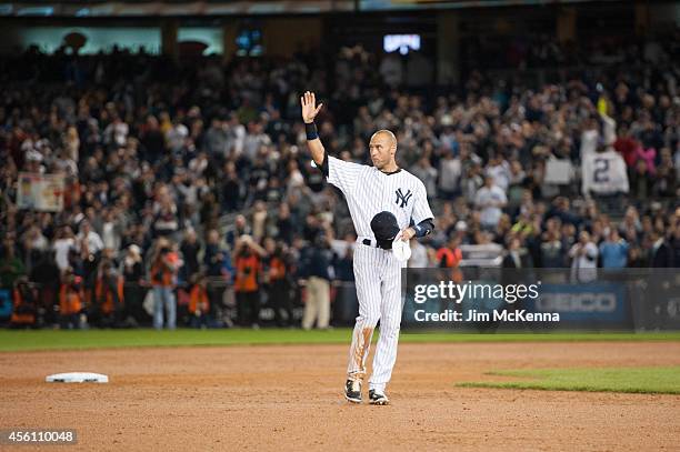 Derek Jeter of the New York Yankees acknowledges the crowd after hitting a walk off single in his last home game to defeat the Baltimore Orioles at...