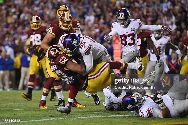 Tackle Will Beatty of the New York Giants tackles inside linebacker Keenan Robinson of the Washington Redskins during 3rd quarter at FedExField on...