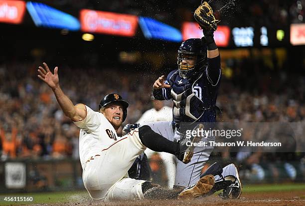 Hunter Pence of the San Francisco Giants scores under the tag of Rene Rivera of the San Diego Padres in the bottom of the seventh inning at AT&T Park...