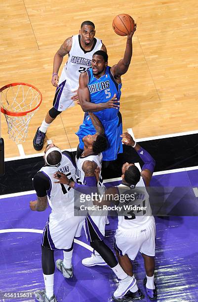 Bernard James of the Dallas Mavericks shoots against Ben McLemore of the Sacramento Kings on December 9, 2013 at Sleep Train Arena in Sacramento,...