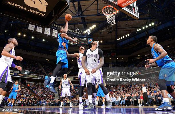 Bernard James of the Dallas Mavericks shoots against Ben McLemore of the Sacramento Kings on December 9, 2013 at Sleep Train Arena in Sacramento,...