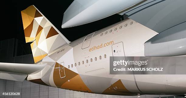 An Airbus A380 with the new design of Etihad Airways is pictured on Septemner 25, 2014 in Hamburg on the Airbus facilities in front of a paint shop....