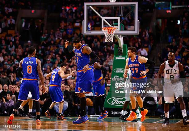 Carmelo Anthony of the New York Knicks celebrates a three-point shot in the first quarter against the Boston Celtics during the game at TD Garden on...