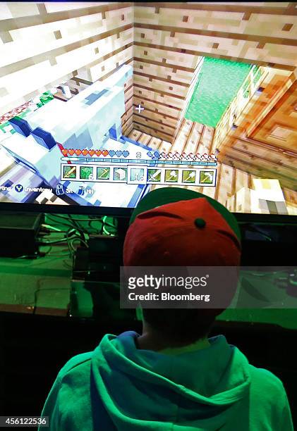 Visitor plays the Minecraft computer came, produced by Mojang AB, on a Microsoft Corp. Xbox One games console during the EGX gaming conference at...