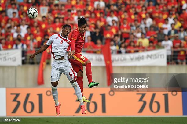 Mac Hong Quan of Vietnam jumps for the ball with Saif Khalfan Saeed Almeqbaali of the United Arab Emirates during their men's round of 16 football...