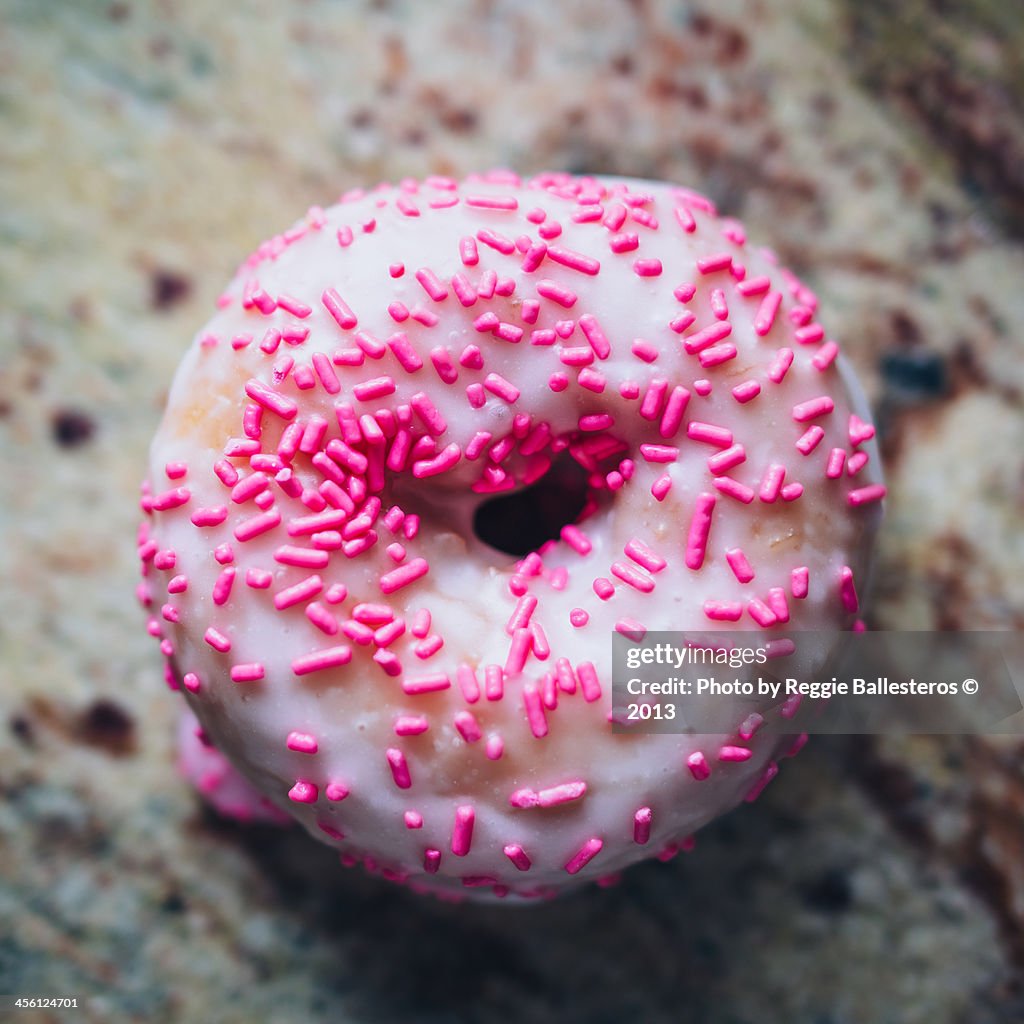 Donut with sprinkles on granite counter top