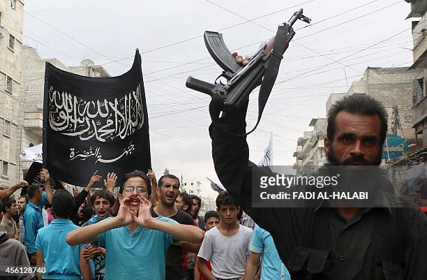 Supporters of the Al Nusra Front take part in a protest against Syrian President Bashar al-Assad and the international coalition in Aleppo on...