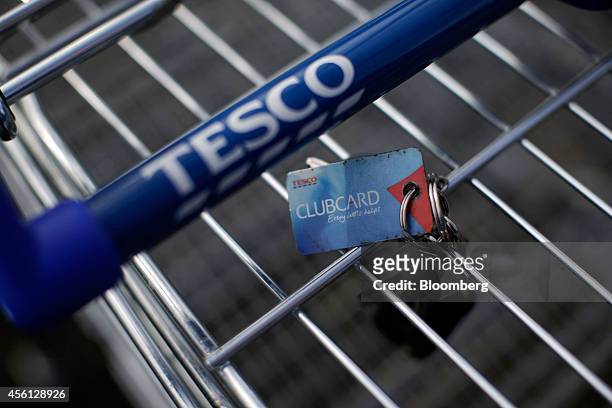 Clubcard rewards card sits attached to keys on a shopping cart outside a Tesco Extra supermarket store, operated by Tesco Plc, in this arranged...