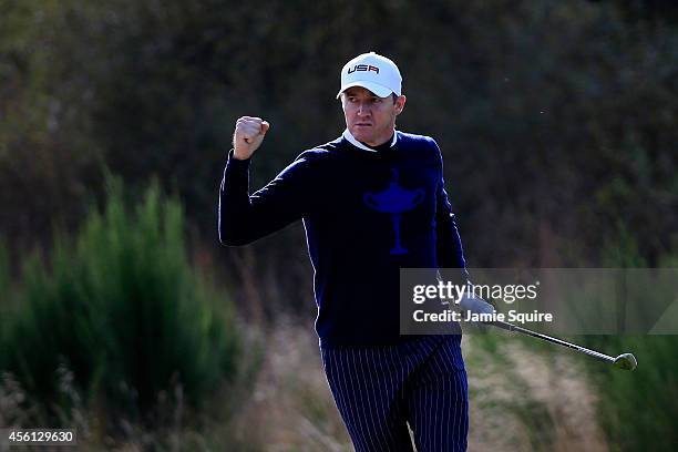 Jimmy Walker of the United States celebrates after chipping in from the bunker on the 9th hole during the Morning Fourballs of the 2014 Ryder Cup on...