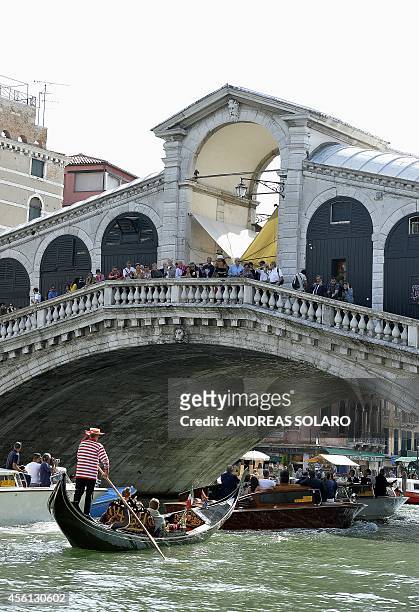 The taxi boat taken by US actor George Clooney and his Lebanon-born British fiancee Amal Alamuddin sails under the Rialto bridge in Venice on...