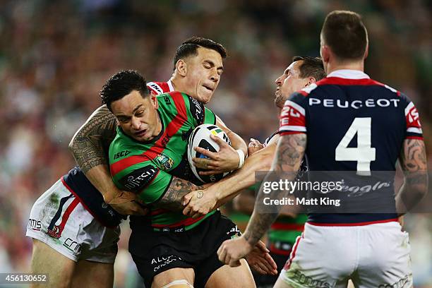 John Sutton of the Rabbitohs is tackled during the First Preliminary Final match between the South Sydney Rabbitohs and the Sydney Roosters at ANZ...