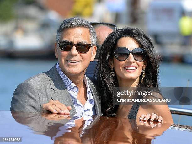 Actor George Clooney and his Lebanon-born British fiancee Amal Alamuddin take a taxiboat upon their arrival in Venice on September 26 on the eve of...