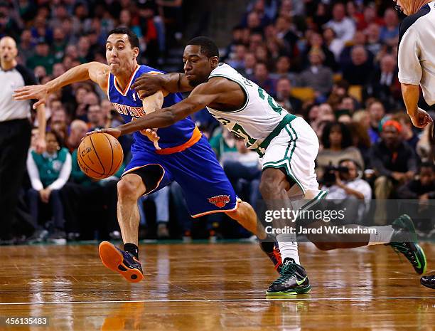 Jordan Crawford of the Boston Celtics and Pablo Prigioni of the New York Knicks reach for a loose ball in the second half during the game at TD...