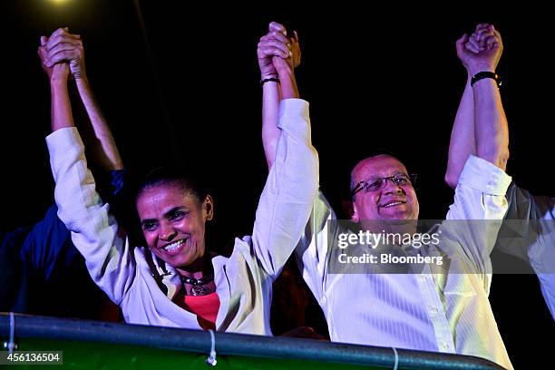 Brazilian presidential candidate Marina Silva, left, and vice-presidential candidate Beto Albuquerque, of the Brazilian Socialist Party, raise their...