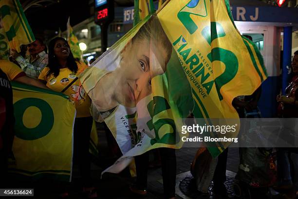 Supporters carry flags during a campaign rally for Brazilian presidential candidate Marina Silva of the Brazilian Socialist Party in Duque de Caxias,...