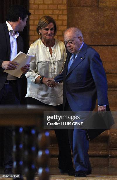 Former president of Catalonia Jordi Pujol sahkea hands with president of Catalan Parliament Nuria de Gispert as he arrives accompanied by president...