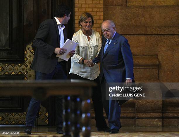 Former president of Catalonia Jordi Pujol sahkea hands with president of Catalan Parliament Nuria de Gispert as he arrives accompanied by president...