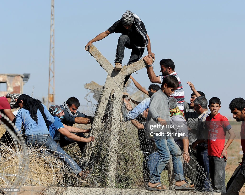 Syrian Kurds Fleeing The Islamic State Militants Cross Into Turkey