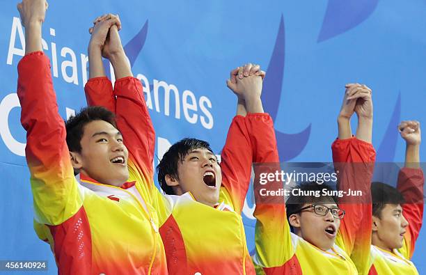 Xu Jiayu, Li Xiang, Li Zhauhao and Ning Zetao of China celebrate after winning the Men's 4 X 100m Medley during the 2014 Asian Games at Munhak Park...