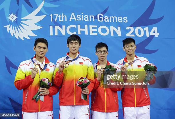 Gold medalists Xu Jiayu, Li Xiang, Li Zhauhao and Ning Zetao of China pose atop the podium after the Men's 4 X 100m Medley Final during the 2014...