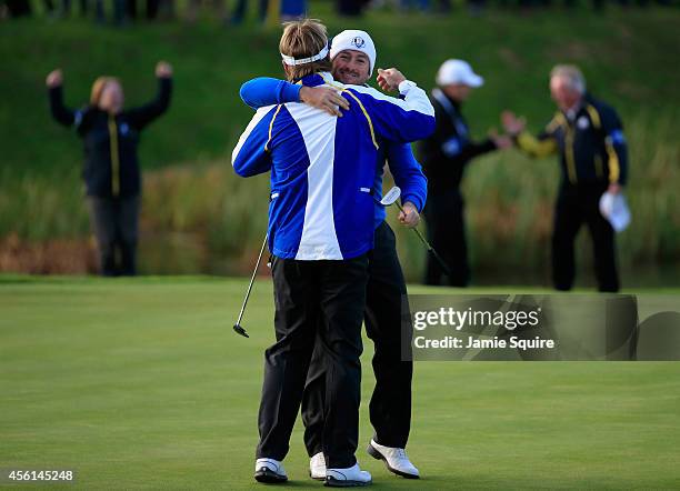 Graeme McDowell of Europe celebrates victory with Victor Dubuisson of Europe on the 16th green during the Afternoon Foursomes of the 2014 Ryder Cup...