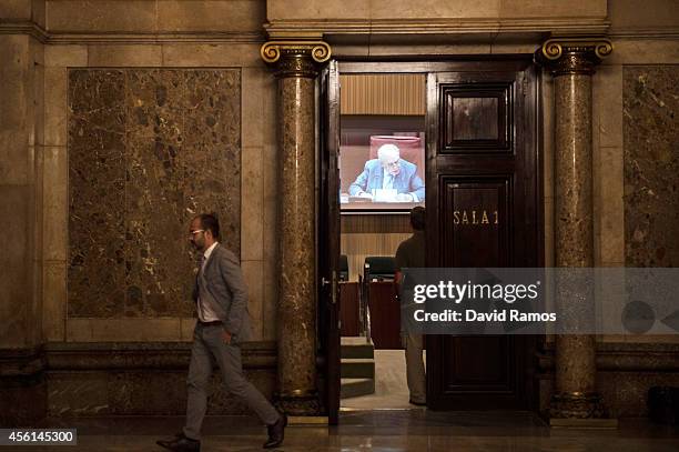 Former Catalan President Jordi Pujol is seen on a screen as he speaks to the members of the parliament on September 26, 2014 in Barcelona, Spain....