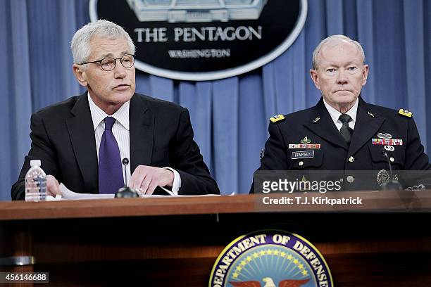 Secretary of Defense Chuck Hagel, left, and Joint Chiefs of Staff Chairman General Martin Dempsey speak to the press about the ongoing bombing...