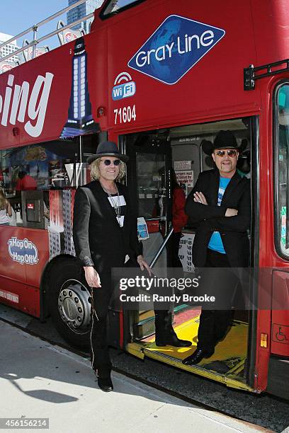 Big & Rich's Big Kenny and John Rich pose in fron of their Greyline "Ride of Fame" tour bus at Pier 78 on September 26, 2014 in New York City.