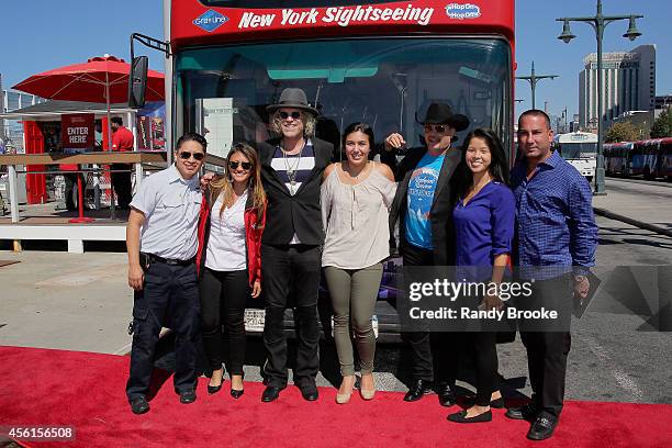 Big & Rich's Big Kenny and John Rich pose with fans in front of their Greyline "Ride of Fame" tour bus at Pier 78 on September 26, 2014 in New York...