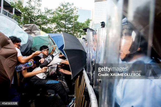 Protesters clash with police during a demonstration at the government headquarters in Hong Kong on September 27, 2014. More than 100 protesters broke...
