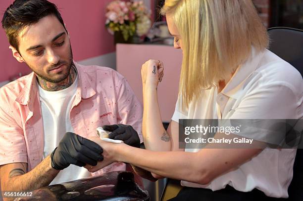 Actress Rumer Willis gets tattooed by artist Romeo Lacoste during Benefit Cosmetics and Vanessa Hudgens Kick-Off National Wing Women Weekend at Space...