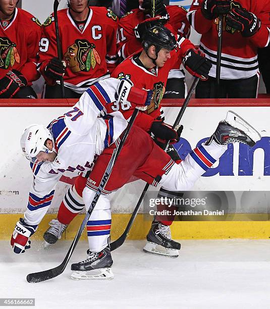 Cody Bass of the Chicago Blackhawks collodes with Lee Stempniak of the New York Rangers during a preseason game at the United Center on September 26,...