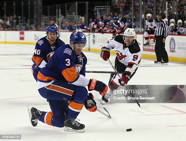 Travis Hamonic of the New York Islanders blcoks a shot by Martin Havlat of the New Jersey Devils at the Barclays Center on September 26, 2014 in the...