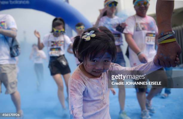 People participate in the annual Color Run in Shanghai on September 27, 2014. The Color Run is a five kilometre race without winners where...