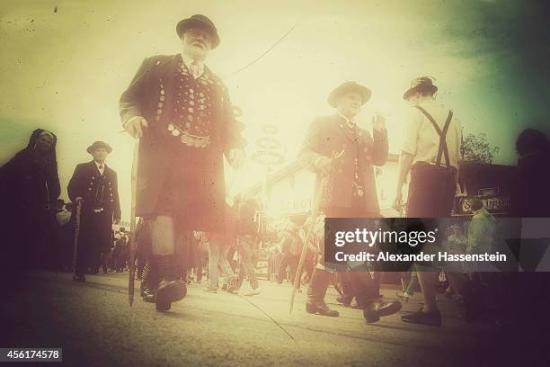 Men and Women dressed in their traditional Bavarian clothing and other traditional Bavarian folk dress march in the Parade of Costumes and Riflemen...