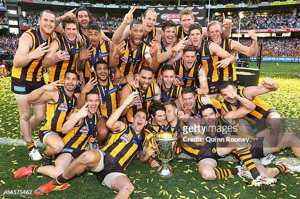 Hawks players celebrate with the Premeirship Cup during the 2014 AFL Grand Final match between the Sydney Swans and the Hawthorn Hawks at Melbourne...