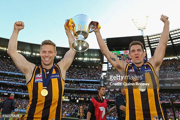Sam Mitchell and Luke Hodge of the Hawks celebrate with the Premeirship Cup during the 2014 AFL Grand Final match between the Sydney Swans and the...
