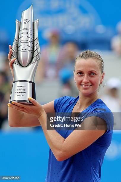 Petra Kvitova of Czech Republic holds the trophy to celebrate at the award ceremony after winning the final match against Eugenie Bouchard of Canada...