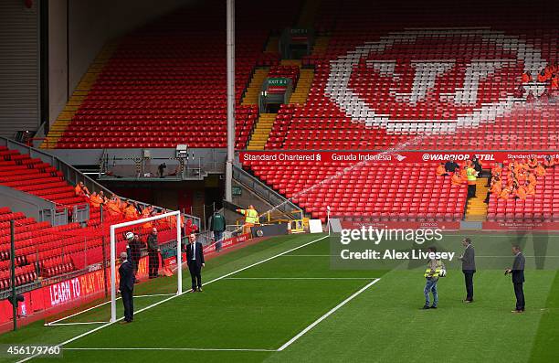 Martin Atkinson the referee of the Barclays Premier League match between Liverpool and Everton tests the goal line technology at Anfield on September...