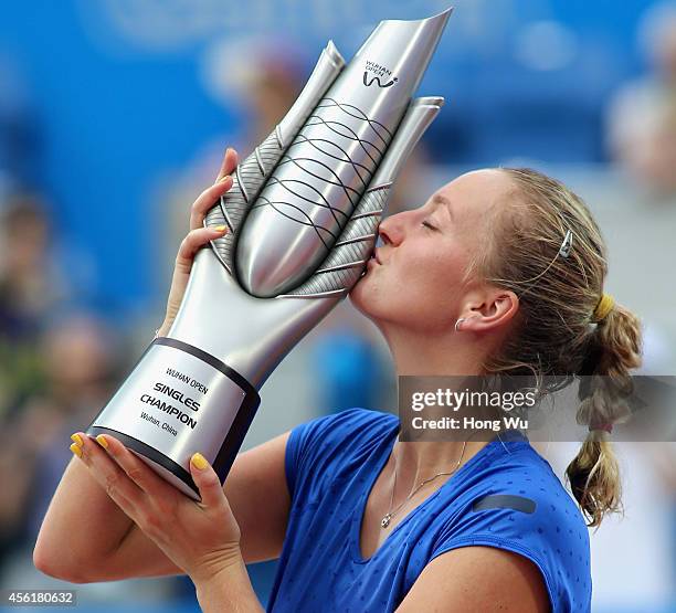 Petra Kvitova of Czech Republic kisses the trophy to celebrate at the award ceremony after won the final match against Eugenie Bouchard of Canada on...