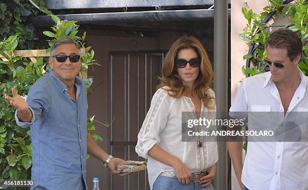 Actor George Clooney , topmodel Cindy Crawford and her husband Rande Gerber leave their table on September 27, 2014 at the Cipriani Hotel in Venice...